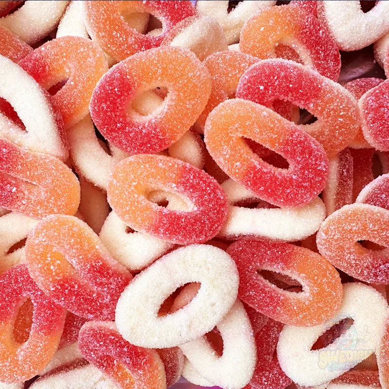 Assorted gummy candy rings in red, orange, and white.