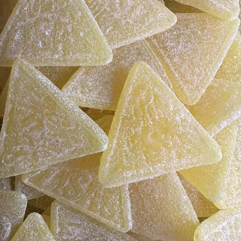 Close-up of triangular gummy candies with a sugary texture.